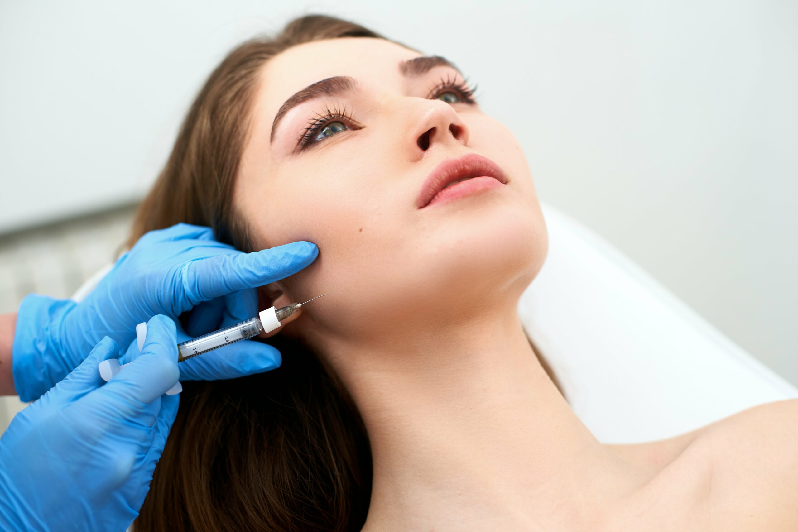 What is Sculptra, and how does it work to enhance facial volume and appearance